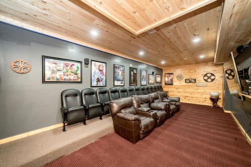 a movie room with a leather couch and chairs at Spectacular Cabin with Incredible Indoor and Outdoor Spaces in Tennessee in Large Island