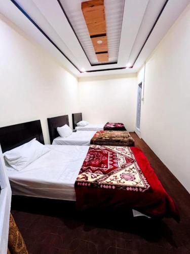 a bedroom with two beds in a room at Moon Guest House in Dargai