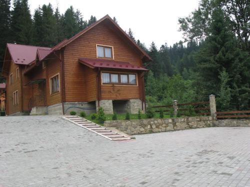 a house with a stone driveway in front of it at Schale Centoriya in Mykulychyn