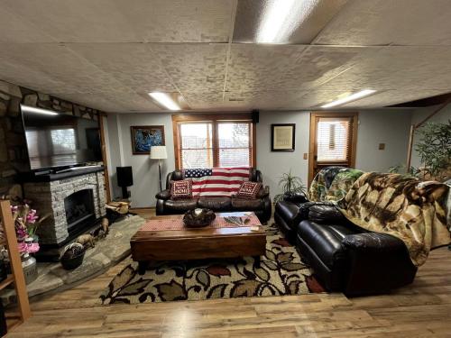a living room with two couches and a fireplace at Peaceful Cabin Perfect for Families in Lawrenceburg, Indiana in Aurora