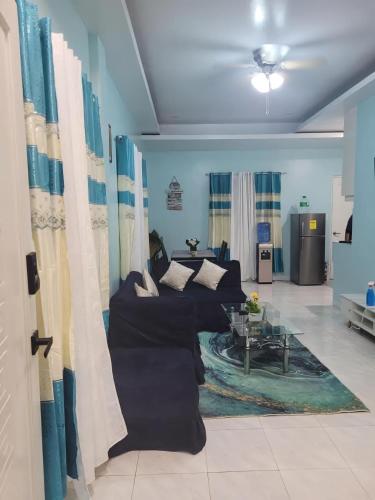 a living room with a couch and a table at Jens Samal Vacation Rental - Centrally Located - Fully Furnished 2br WIFI in Babak