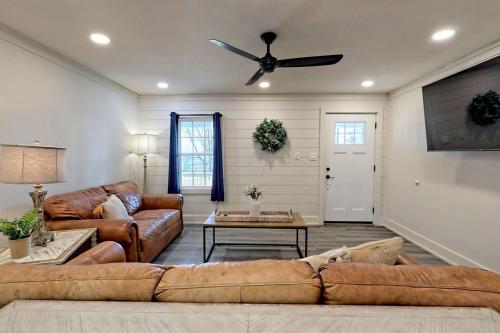 a living room with a couch and a ceiling fan at Serene Cottage with Remodeled Interior and Gorgeous Pastures Views in Georgia in Shirley Grove