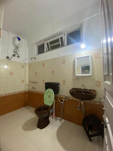 a bathroom with a toilet and a sink at Sadamo Homestay in Darjeeling