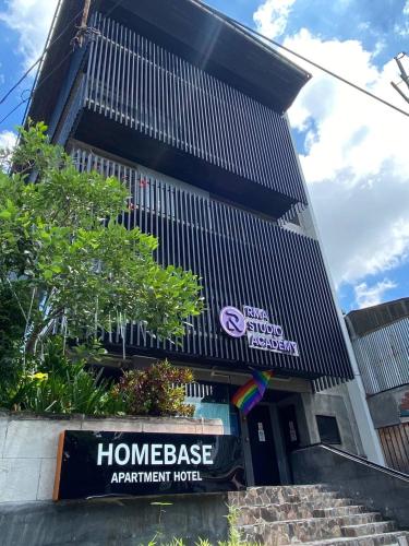 a building with a sign in front of it at HomeBase Apartment Hotel in Manila