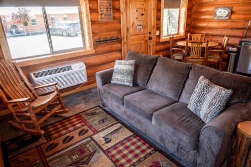 a living room with a couch and chairs in a cabin at Rustic-Chic Log Cabin with King Bed & Kitchen | Bonners Ferry, Idaho Retreat in Bonners Ferry