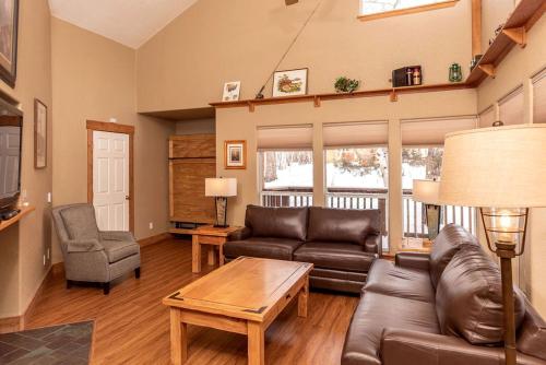 a living room with a couch and a table at Rustic Camping Cabin near the Royal Gorge in Salida, Colorado in Monarch