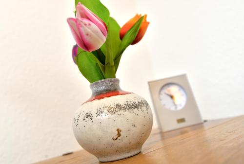 a vase with flowers in it sitting on a table at Haus Daniela Superior in Cochem