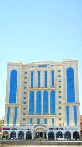 a large building with blue windows on it at Casa Diora Hotel Al Naseem in Jeddah