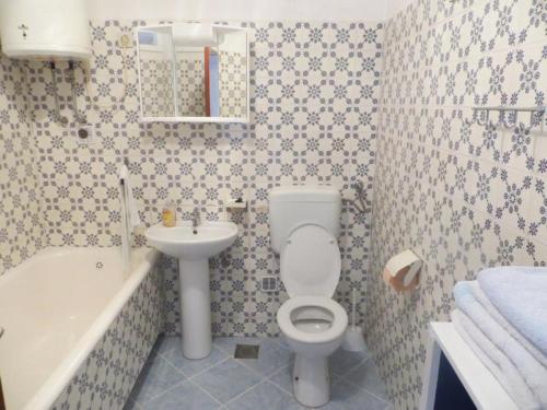 a bathroom with a toilet and a sink at Apartments Viva Ciovo in Slatine