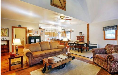 a living room with a couch and a table at Light-Filled, Well-Appointed Mountain Cabin for a Vacation in Wells, Vermont in Wells