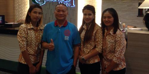 a man and three women posing for a picture at The Centris Hotel Phatthalung in Phatthalung