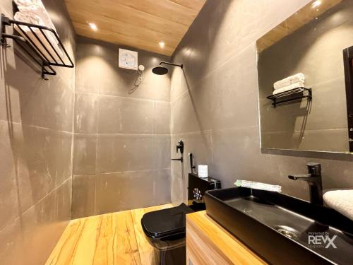 a bathroom with a sink and a mirror at Anupraas Resort in Lansdowne
