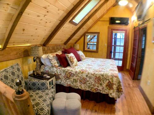 a bedroom with a bed in a wooden room at Magical Tree House Experience with a Private Hot Tub in Shenandoah Valley, Virginia in Grove Hill