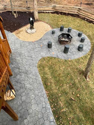 a stone patio with a fire pit in a yard at Magical Tree House Experience with a Private Hot Tub in Shenandoah Valley, Virginia in Grove Hill