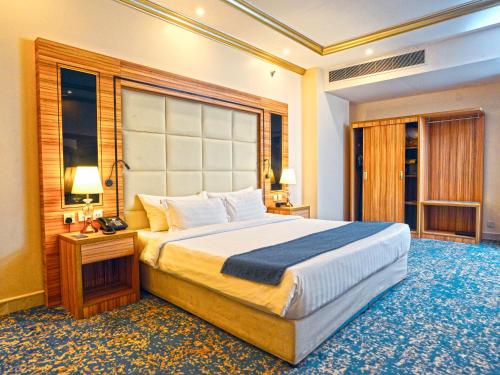 a bedroom with a large bed in a room at Casa Diora Hotel Al Naseem in Jeddah