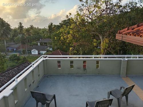 a view from the roof of a house with chairs at Villa Auro in Hikkaduwa