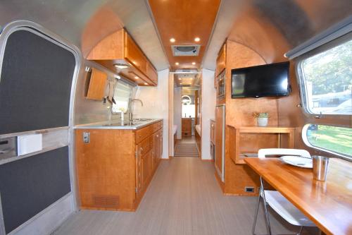 an interior view of a kitchen in an rv at Classy Airstream Land Yacht Rental with Modern Amenities near Gatlinburg, Tennessee in Shady Grove