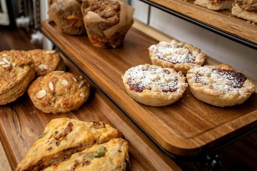 a bunch of muffins on display in a bakery at Exquisite Zen Suite Retreat near Blue Ridge Mountain in Virginia in Luray