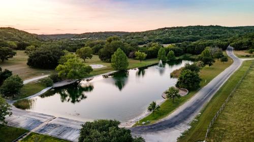 an aerial view of a river with trees and a road at Beautiful Glamping Tented Cabin in Ingram, Texas, with Access to the Guadalupe River in Hunt