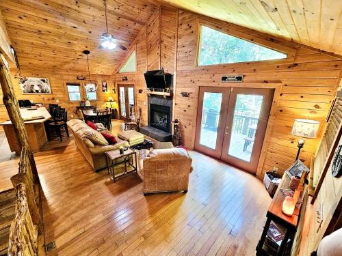 a living room with a couch and a fireplace at Awesome Comfy Cabin with Jacuzzi, Game Room and Screened Porch in Georgia in Helen