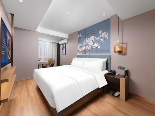 Ένα ή περισσότερα κρεβάτια σε δωμάτιο στο Magnotel Classic Shenyang General Hospital of Northern Theater Command