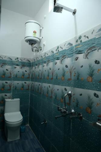 a bathroom with a toilet and a shower and a sink at maa kalishila home stay in Ukhimath