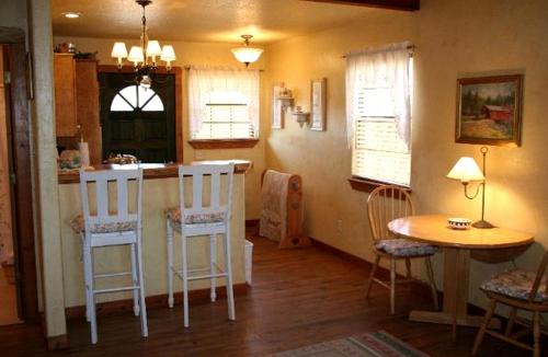 a kitchen with a bar and a table and chairs at Sweet Cabin Rental for Family-Friendly Getaway near New Braunfels, Texas in Buda