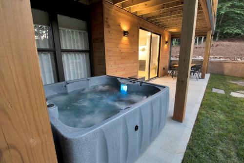 a jacuzzi tub on the side of a house at Luxury Mountain Retreat with Hot Tub Near Lake Hartwell & Clemson, SC in South Union
