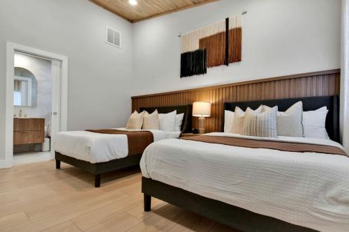 a bedroom with two beds and a bathroom with a sink at Luxury Mountain Retreat with Hot Tub Near Lake Hartwell & Clemson, SC in South Union