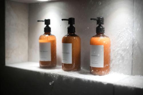 three bottles of soap on a shelf in a bathroom at Luxury Mountain Retreat with Hot Tub Near Lake Hartwell & Clemson, SC in South Union
