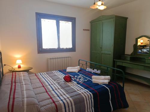 a bedroom with a bed with a blanket and a window at Villa Bruna by Holiday World in Pisogne