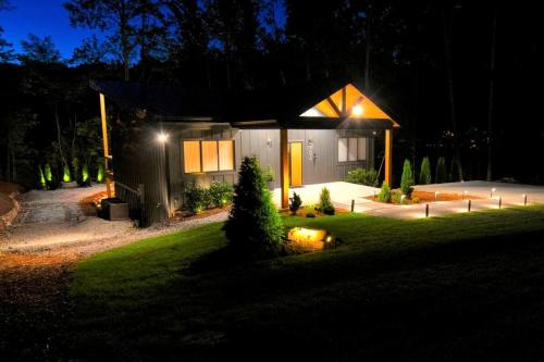 a house at night with lights in the yard at Luxury Mountain Retreat with Hot Tub Near Lake Hartwell & Clemson, SC in South Union