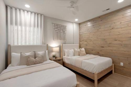 a bedroom with two beds and a wooden wall at Luxury Mountain Retreat with Hot Tub Near Lake Hartwell & Clemson, SC in South Union