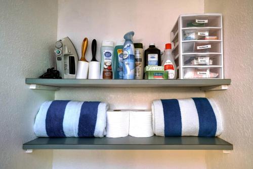 a shelf with towels and other items in a bathroom at Wonderful A frame Nestled Amidst Trees in Otter Rock, Oregon in Otter Rock