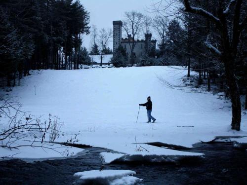 a person is cross country skiing in the snow at Spectacular Gothic-Style Castle with Private Pool and Hot Tub near Rindge, New Hampshire in Rindge