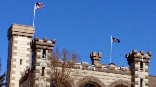 two american flags on top of a castle at Spectacular Gothic-Style Castle with Private Pool and Hot Tub near Rindge, New Hampshire in Rindge