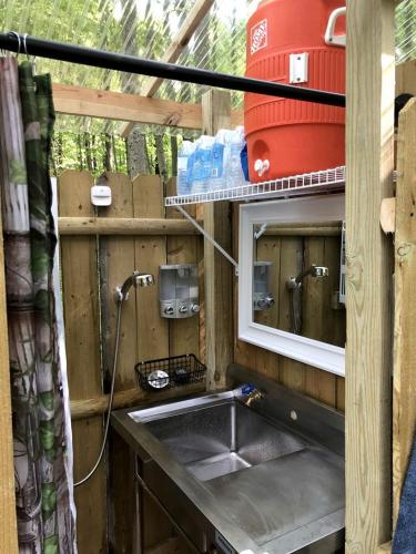 a kitchen with a sink and a mirror at Luxurious Safari Tent in Cooperstown, NY - Perfect Glamping Spot for a Romantic Getaway in Cooperstown