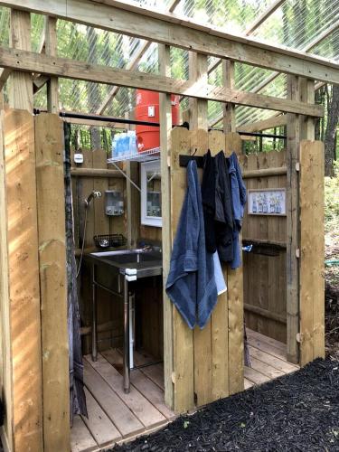 a wooden outdoor kitchen with a sink and a counter at Luxurious Safari Tent in Cooperstown, NY - Perfect Glamping Spot for a Romantic Getaway in Cooperstown
