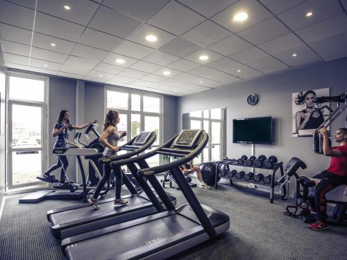 a group of people in a gym with tread machines at Novotel Bourges in Bourges
