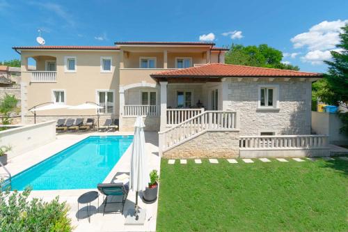 a villa with a swimming pool and a house at Villa Coridigo - Unique High Position, Panorama Nature View, Cozy Dining Terrace, Fenced Property in Kringa