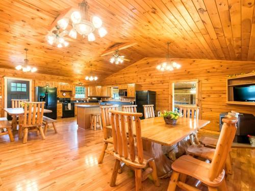 a kitchen and dining room with a table and chairs at Gorgeous and Spacious Cabin Rental for a Group Vacation near Hocking Hills State Park, Ohio in Cedar Grove