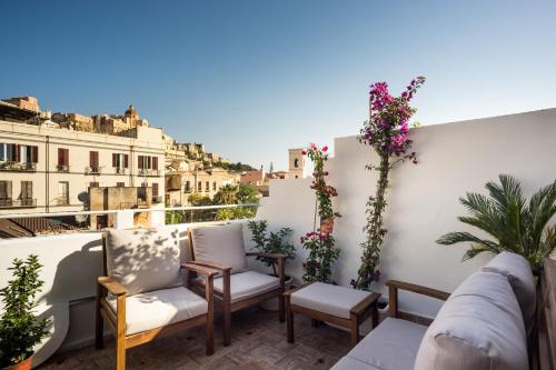 a balcony with chairs and a view of the city at Domus Karalis in Cagliari