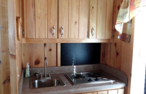 a kitchen with a sink and a stove at Simple Weekend Getaway near the Black Hills Region of South Dakota in Sundance