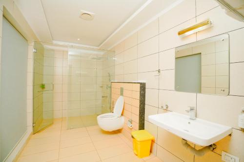 a bathroom with a toilet and a sink at Vaidekam Resorts & Wellness, Kannur in Kannur