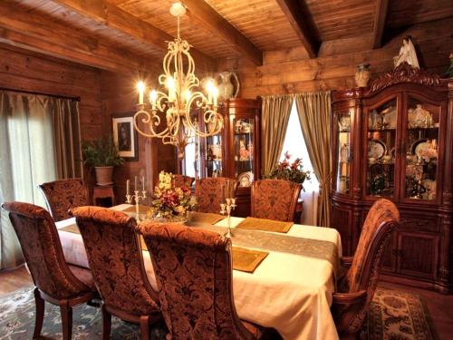 a dining room with a table and chairs and a chandelier at Rustic Room Rental for a Vacation near Harrison, Arkansas in Ponca