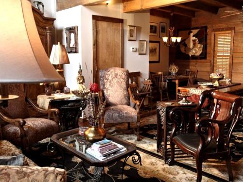 a living room filled with furniture and a table at Rustic Room Rental for a Vacation near Harrison, Arkansas in Ponca