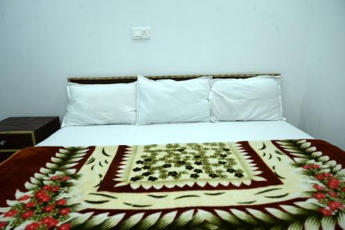 a bed with a cake on top of it at maa kalishila home stay in Ukhimath