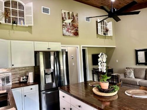 a kitchen with a refrigerator and a table in it at Comfy Equipped Lodge Great for a Peaceful Getaway in Texas in Waelder