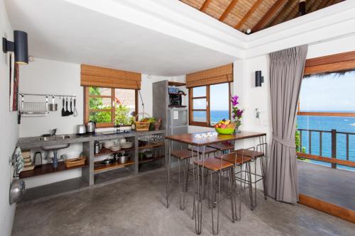 a kitchen with a view of the ocean at The Fisherman's Villas in Koh Tao