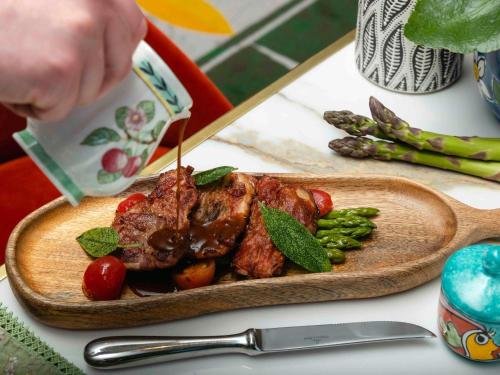 a plate of food with meat and vegetables on a table at Sofitel Luxembourg Europe in Luxembourg